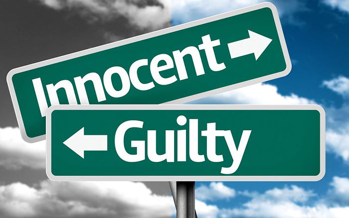 Picture of 2 street signs, one says "Innocent" and the other says "Guilty"