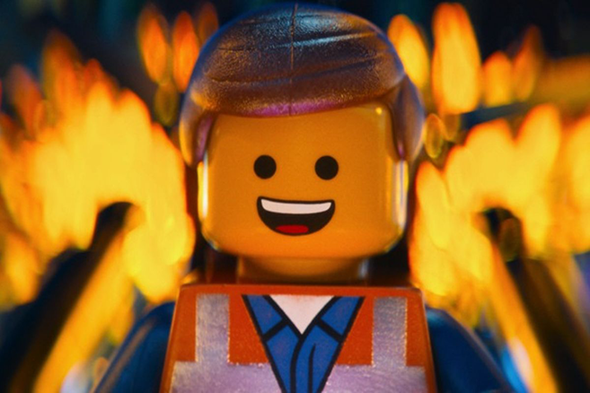 Picture of main character from The Lego Movie, with a building burning behind him